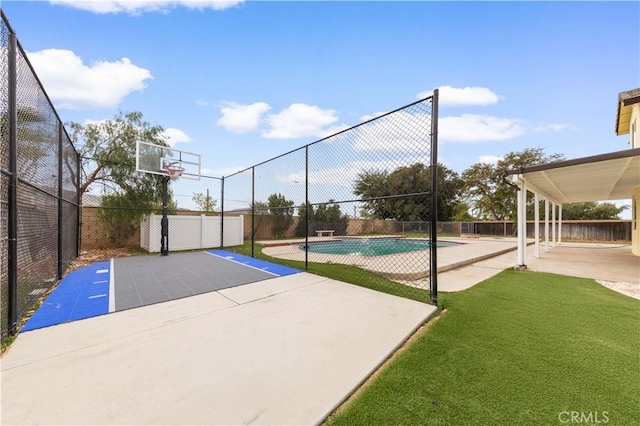 view of basketball court featuring a fenced in pool and a lawn