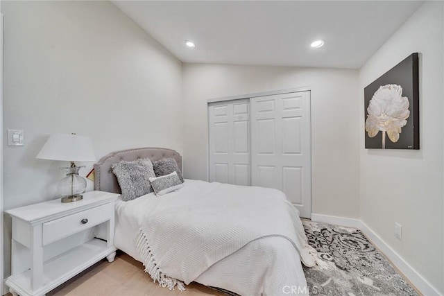 bedroom featuring vaulted ceiling and a closet