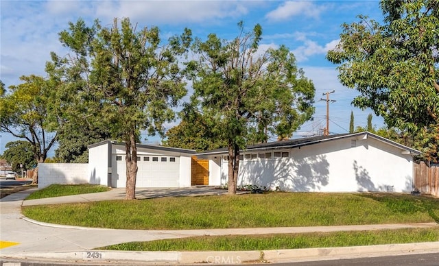 ranch-style house with a garage and a front yard