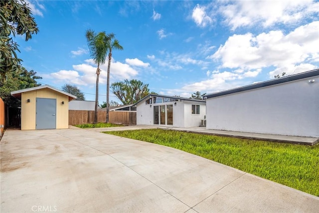 exterior space with a storage shed and a lawn