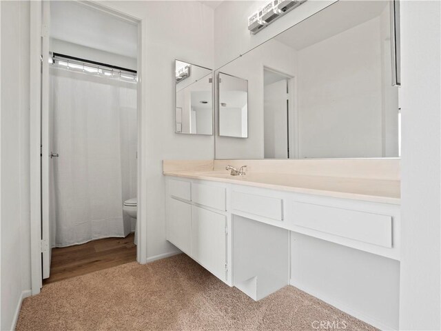 bathroom featuring vanity, a shower with curtain, and toilet