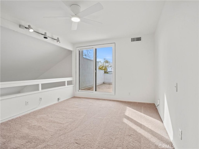 spare room with vaulted ceiling, carpet floors, and ceiling fan