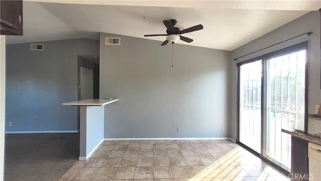 unfurnished room with ceiling fan and vaulted ceiling