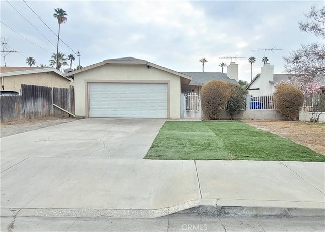 view of front of property featuring a garage and a front lawn