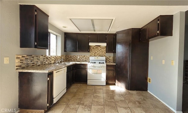 kitchen with dark brown cabinetry, sink, white appliances, and decorative backsplash