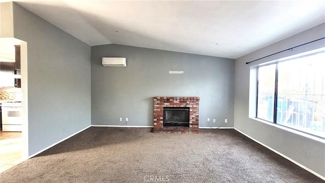 unfurnished living room with carpet floors, a fireplace, a wall mounted AC, and vaulted ceiling