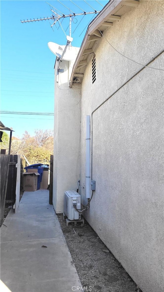 view of side of property with ac unit and a patio area