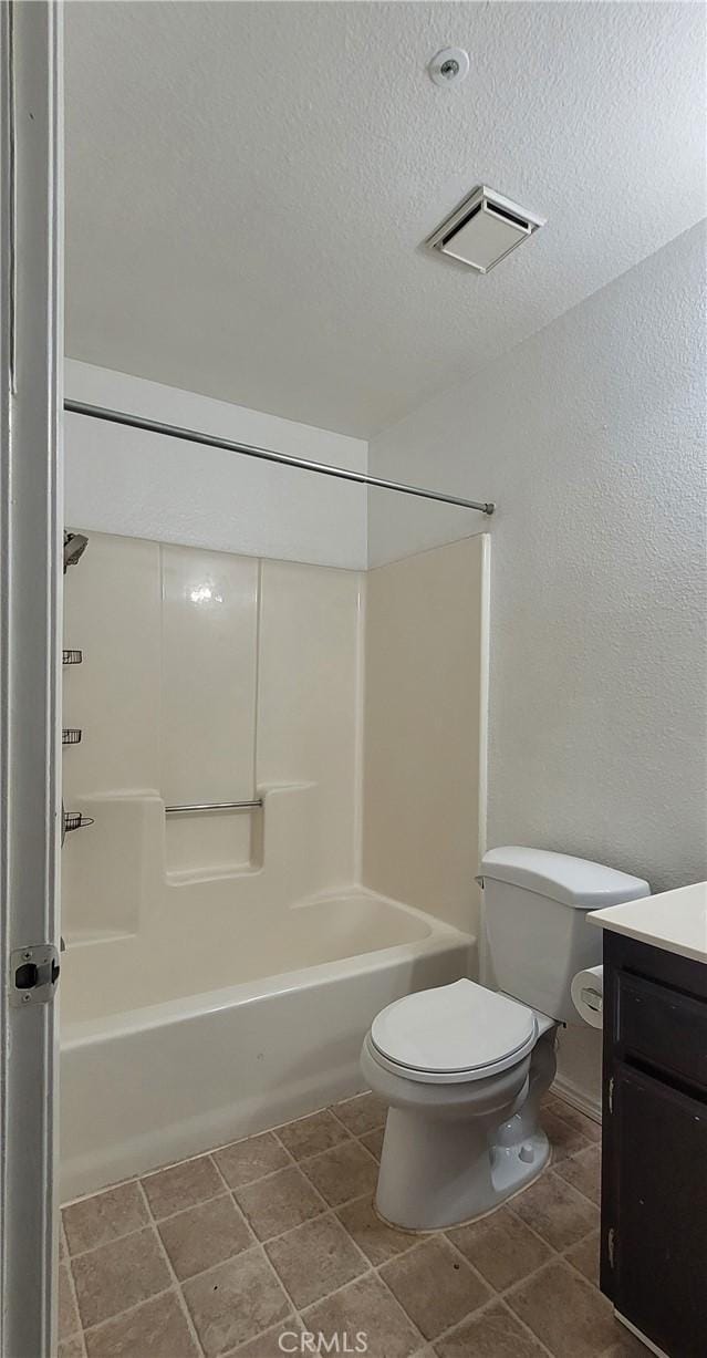 full bathroom featuring vanity,  shower combination, a textured ceiling, and toilet