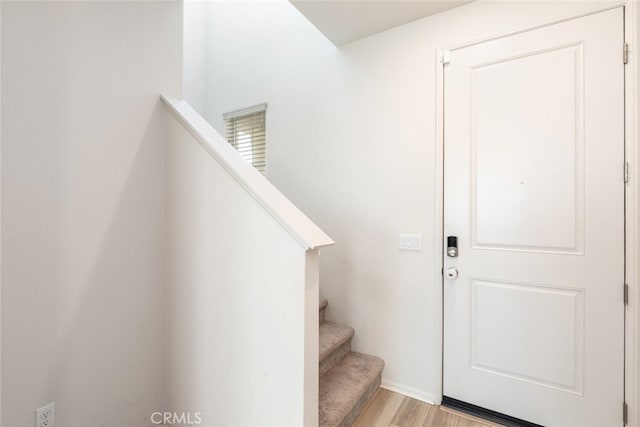 stairs with hardwood / wood-style flooring