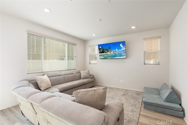 living room featuring a wealth of natural light and light hardwood / wood-style floors