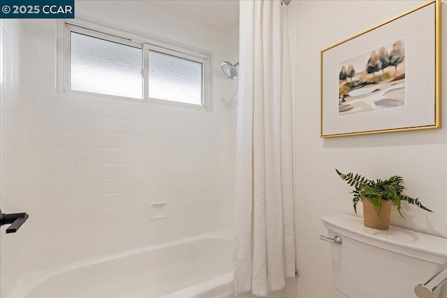 bathroom with toilet and shower / bath combo with shower curtain