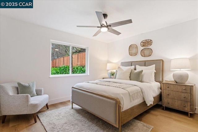 bedroom with ceiling fan and light wood-type flooring