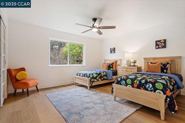 bedroom with ceiling fan and light hardwood / wood-style flooring