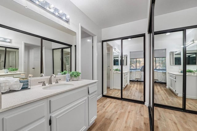 bathroom featuring hardwood / wood-style flooring and vanity