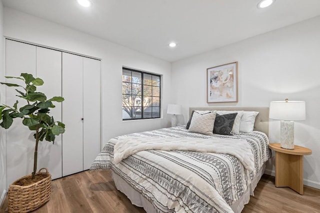 bedroom with hardwood / wood-style floors and a closet