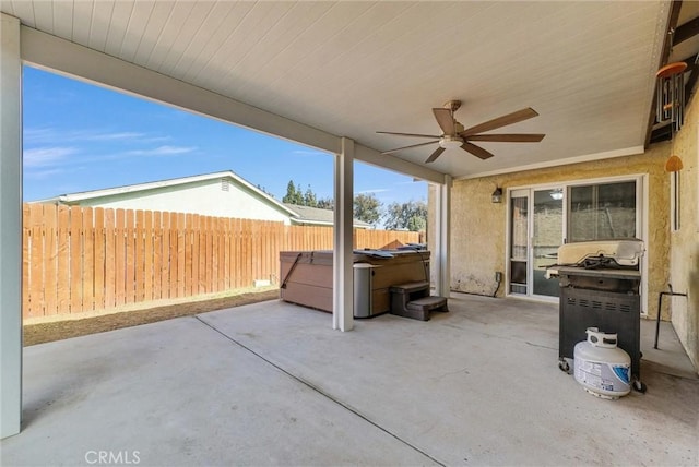 view of patio / terrace featuring a hot tub, a grill, and ceiling fan