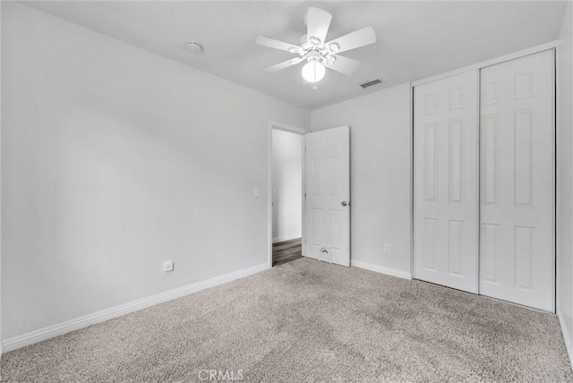 unfurnished bedroom featuring ceiling fan, a closet, and carpet