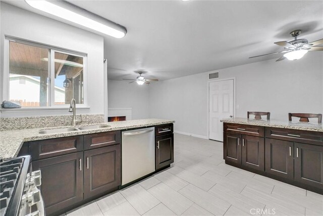 kitchen with stainless steel appliances, ceiling fan, sink, and dark brown cabinetry