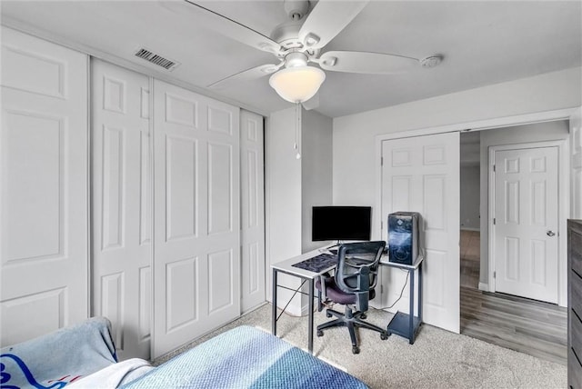 carpeted bedroom with ceiling fan and a closet