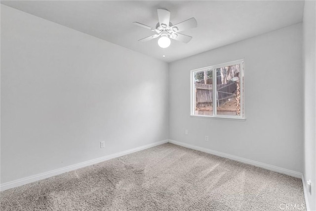 spare room featuring ceiling fan and carpet floors