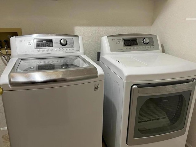 clothes washing area featuring independent washer and dryer