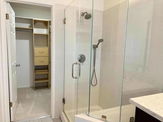 bathroom featuring vanity and a shower with shower door