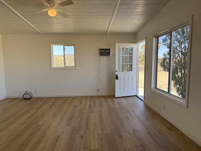 unfurnished sunroom featuring wood ceiling, ceiling fan, and a wall unit AC