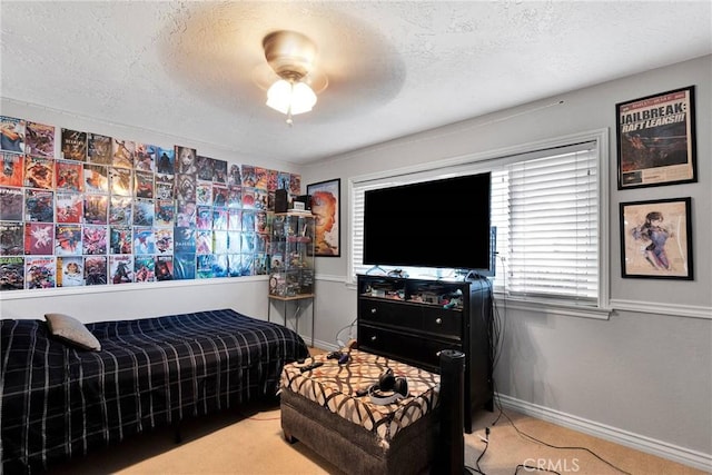 bedroom with ceiling fan and a textured ceiling