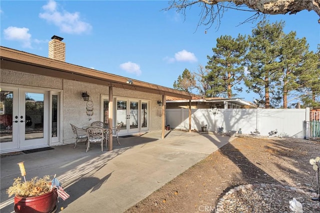 back of property with french doors and a patio