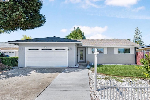 ranch-style house featuring a garage and a front yard