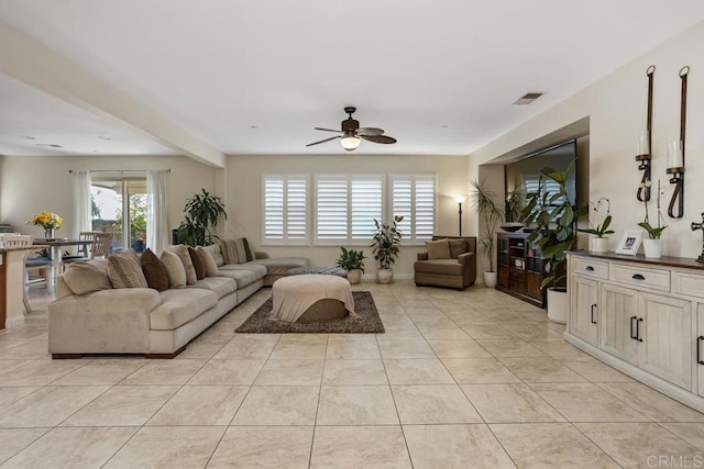 living room with ceiling fan and light tile patterned floors