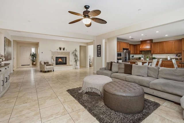 tiled living room with sink and ceiling fan