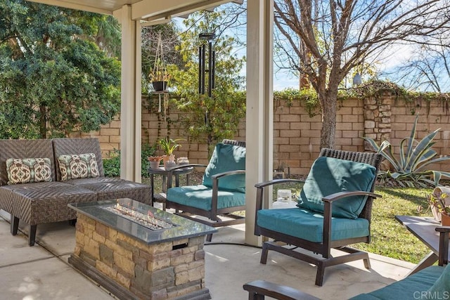 view of patio featuring an outdoor living space with a fire pit