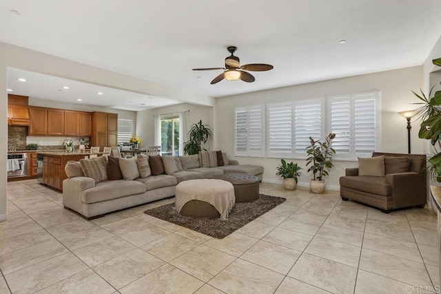 living room featuring light tile patterned floors and ceiling fan