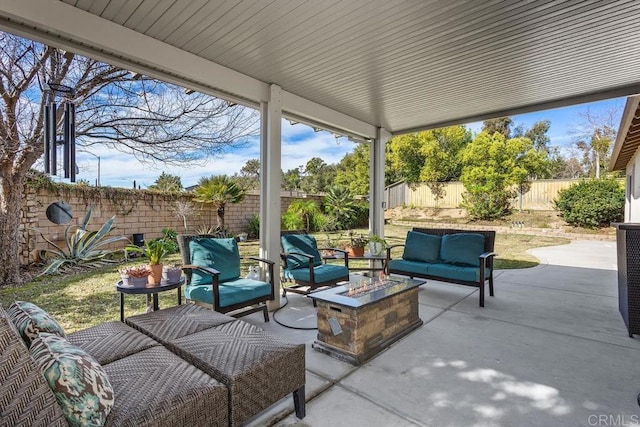 view of patio with an outdoor living space with a fire pit