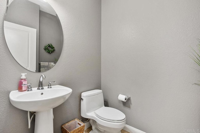 bathroom featuring sink and toilet