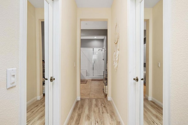 corridor with light wood-type flooring