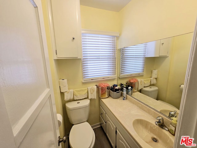 bathroom featuring vanity and toilet