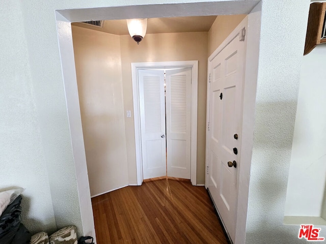 corridor featuring dark hardwood / wood-style flooring