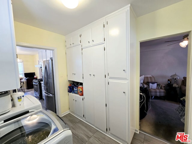 washroom with ceiling fan, cabinets, and washer / clothes dryer