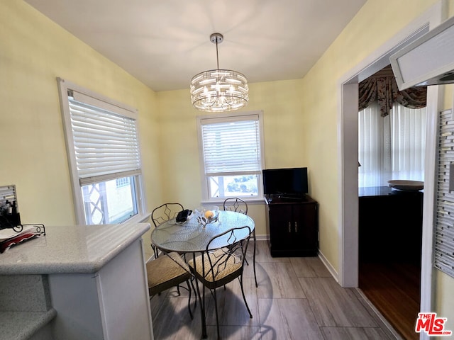 dining area with plenty of natural light and a notable chandelier