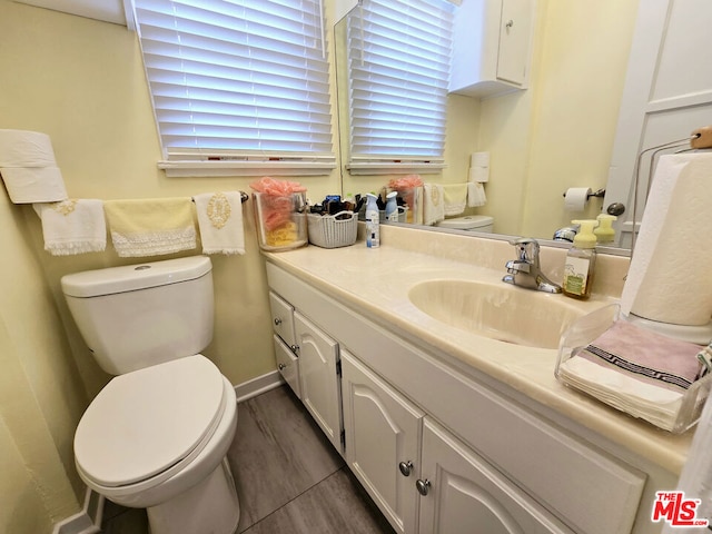 bathroom featuring hardwood / wood-style flooring, vanity, and toilet