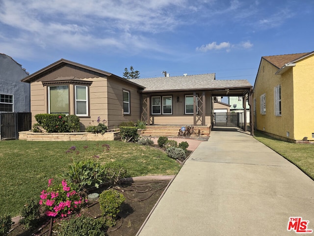 ranch-style home featuring a carport and a front lawn