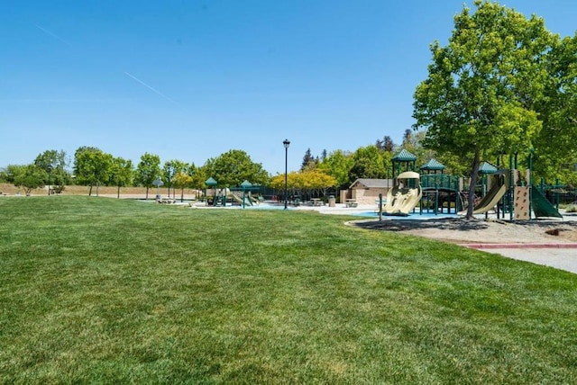 view of home's community with a yard and a playground