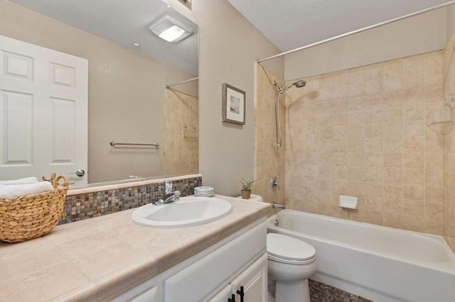 full bathroom featuring vanity, toilet, and tiled shower / bath combo