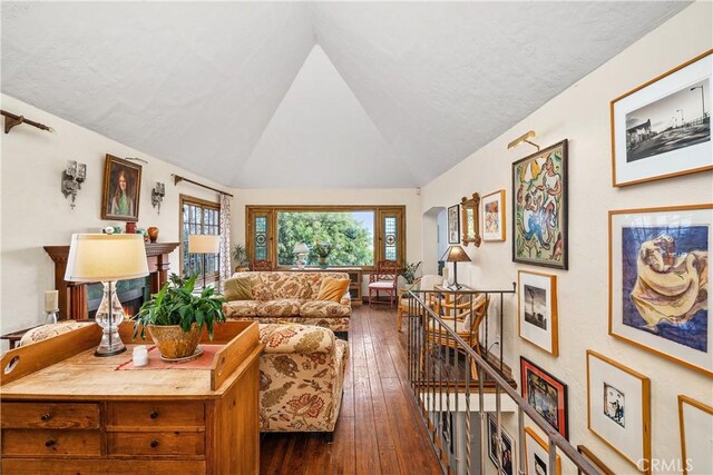 living room with lofted ceiling and dark hardwood / wood-style flooring