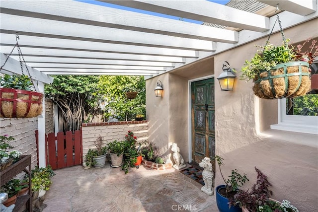 view of patio featuring fence and a pergola