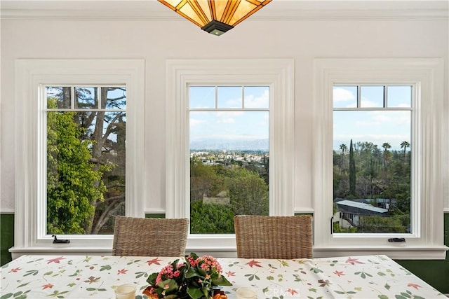 doorway to outside featuring ornamental molding and a wealth of natural light