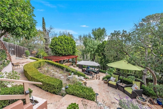 view of community featuring fence, outdoor lounge area, a pergola, and a patio