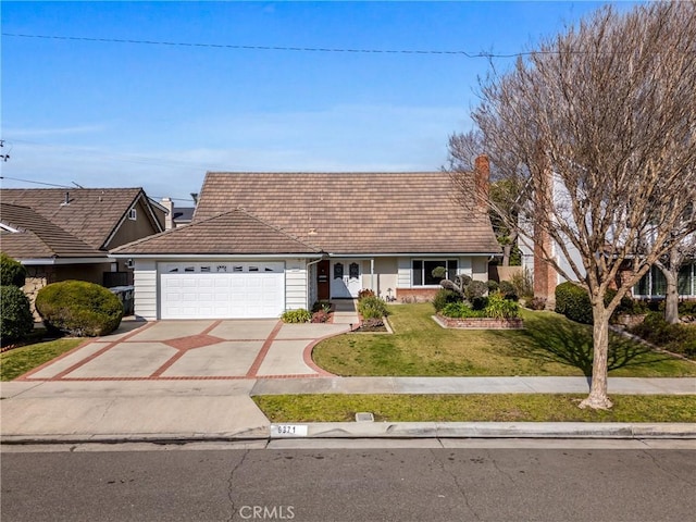 ranch-style house with a garage and a front lawn